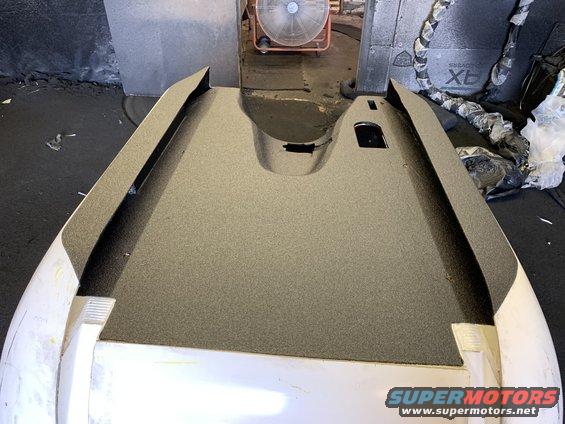 Car hood with textured surface and cutouts