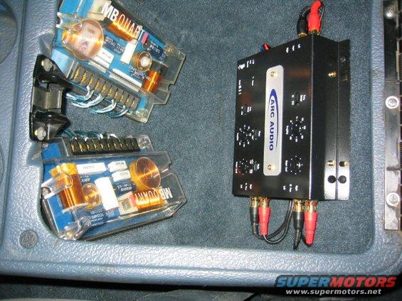 Shows what a little hardboard, bondo, chop mat and scrap carpet can get you. 

Quart 3 way Reference crossovers for the front stage, ARC active network to the amps. 20hz fmods and line driver underneath the ARC.
