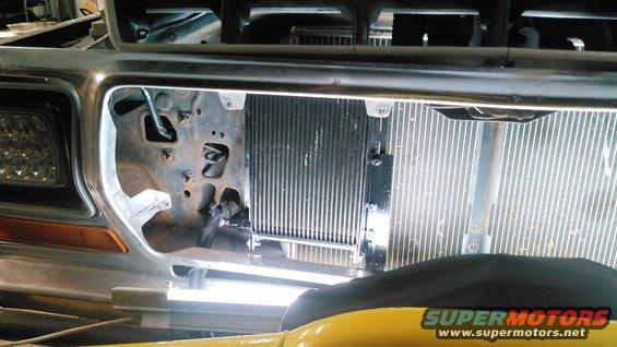 Front grille and radiator of a truck, with Supermotors.net logo visible
