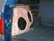 1989 Ford Bronco - Custom subwoofer enclosure being installed in the rear cargo area of a blue vehicle.