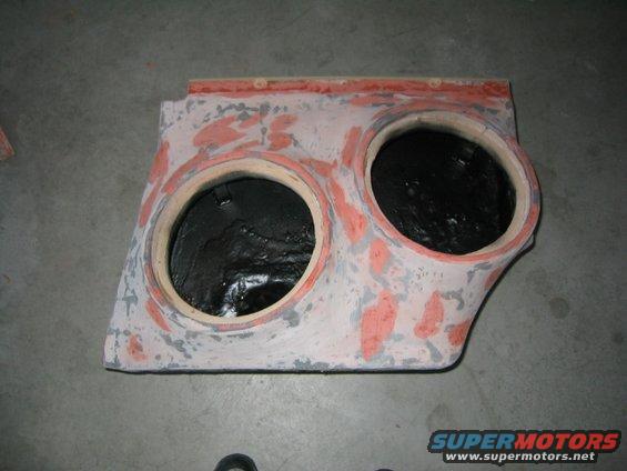Custom-made dual subwoofer enclosure, unfinished, with two circular openings for speakers