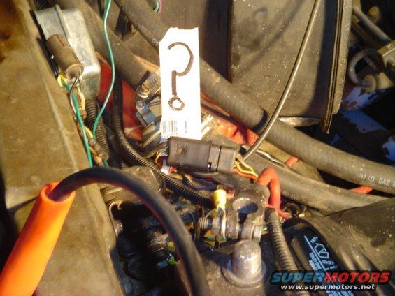 Engine bay with a question mark tag on wiring