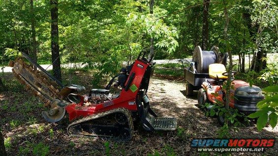 img_20190518_124410_01.jpg Since I had dug it just a year before with the track-hoe, I was able to use this lighter, cheaper trencher to go back with the bigger cable.  And on the flatter ground near the house, the lawn tractor was easier to pull the trailer with.

After I got it buried, I called again to get connected.  A couple weeks later, they sent out an installer in a van who obviously couldn't do anything.  After a couple of months arguing with them, they finally sent out someone who understood what needed to be done, and then told me it was the wrong cable. But they did offer to install the right cable for $11,000.

After a few more weeks arguing, they decided to try using this cable.  About a month later, it still wasn't connected.