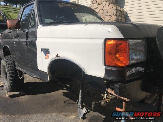 White fender and orange turn signal on a black Ford F-Series truck
