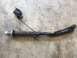 1989 Ford Bronco - A damaged metal part with an electrical connector and wire is shown on a concrete floor.