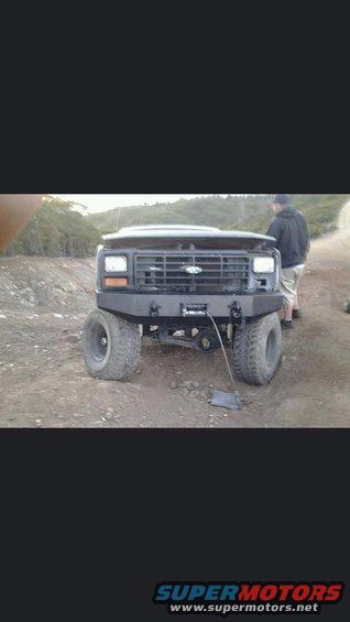 Black Ford Bronco with aftermarket bumper and winch, front view