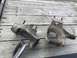 1989 Ford Bronco - Two vehicle suspension parts, possibly from a Ford Bronco, are laid out on a wooden deck.