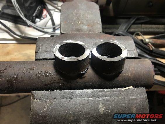 Two cut metal pipe sections clamped in a vise