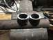 1989 Ford Bronco - Two metal pipe sections are clamped in a vise, ready for further work.