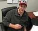 2008 Ford Focus - Man in an office setting, wearing a cap and fleece jacket, holding eyeglasses.