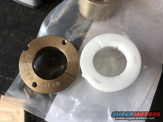 Two bearing collars, one brass with 'REID RACING' text, one white plastic