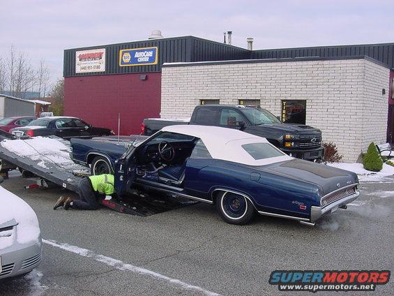 towed-002.jpg This is a shot of my car getting towed.  When I took the car in a month ago, it was sunny and hot.  Now it has no brakes and I am towing it to a new shop down the street.