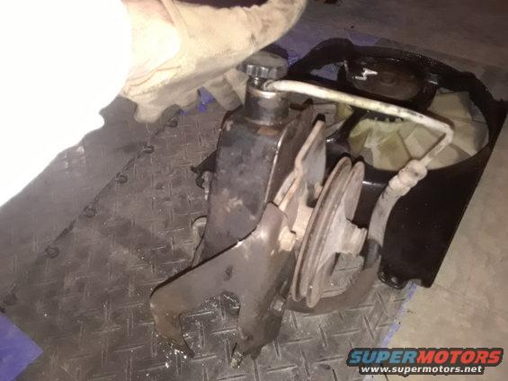 Power steering pump with pulley and fan shroud removed from engine bay