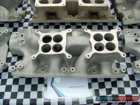 Aluminum dual quad intake manifold with four carburetor mounting holes on each side