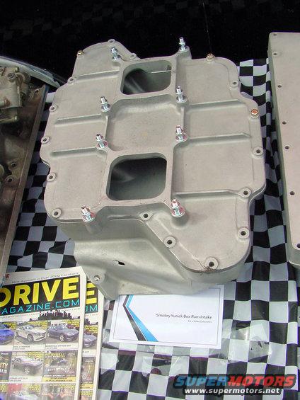 Smokey Yunick Box Ram Intake part on a checkered cloth with a magazine