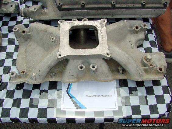 Aluminum intake manifold with a square carburetor mounting flange, labeled 'Roush 4V Single Plane Intake'