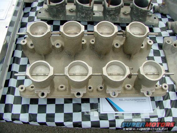 Dual quad throttle body intake manifold with "Pete Jackson Fuel Injection" label