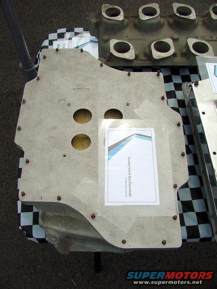 Smokey Yunick Boss Ram Intake part on checkered cloth with another engine part behind it