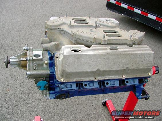 1969 Ford Mustang Boss 302 intake manifold and valve covers on a red engine stand