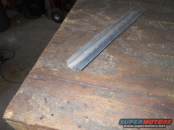 metal trim piece on a wooden workbench