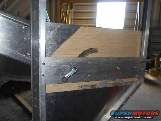 Metal jig with a circular saw blade and crank handle, likely for cutting metal