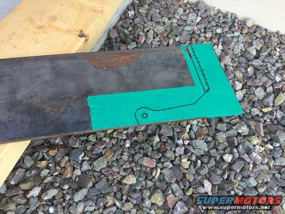 metal bar with green tape and drawn lines