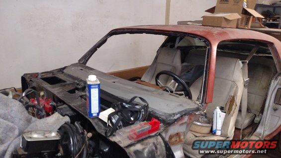 1979 Chevrolet Camaro project car interior with missing windshield and dashboard components