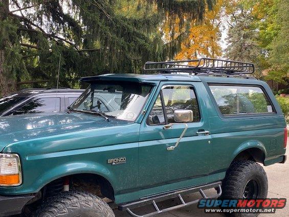 Green 1996 Ford Bronco with roof rack, seen from 3/4 front