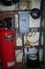 1995 Ford Bronco - A workshop scene an air compressor, electrical panel, and various hoses and cords.