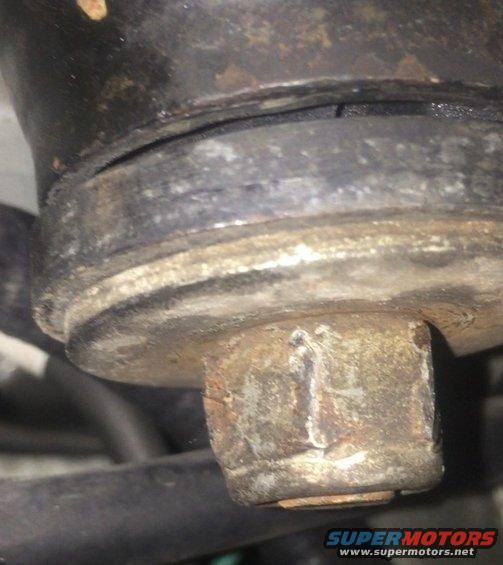 close-up of a rusty bolt and part of a suspension component