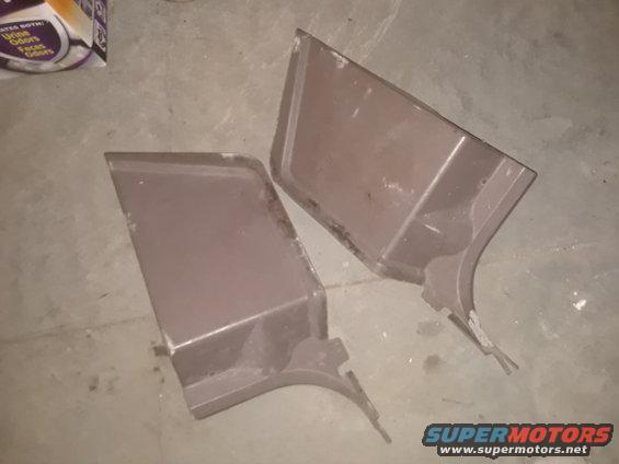 two brown car door panels on a concrete floor