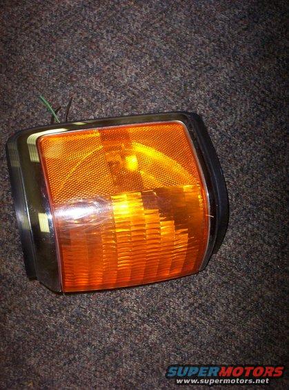 Orange turn signal light with chrome trim and wires