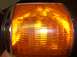 1988 Ford Bronco - Close-up of an amber turn signal assembly, likely from a vehicle's front end.