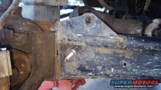 kimg0174.jpg due to the shocks being soo much longer that i should have really used i to change one of the mounting positions so it would not bottom out on collapse. i could not raise the F250 towers higher due to the A/C box so i lowered the bottom mounting point.

i decided the best way to lower it would be drilling a 1/2&quot; hole just below one of the main tubes of my extended radius arms. then use 1/2&quot; steel bushings to extend it out from radius arm. i later welded the bushings to the radius arm for support.