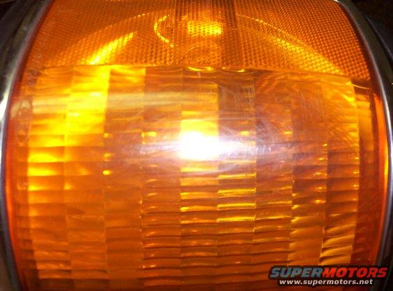 Close-up of an orange turn signal with textured lens