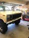 1981 Ford Bronco - A Ford Bronco is parked in a garage with tools and equipment visible in the background.