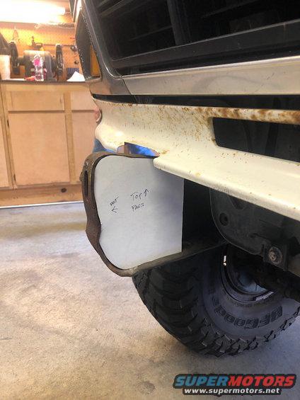 Front bumper with paper template showing 'Top' and 'Faces'