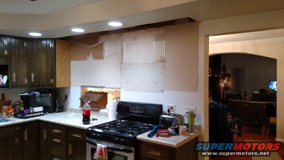 Kitchen under renovation with exposed walls and appliances