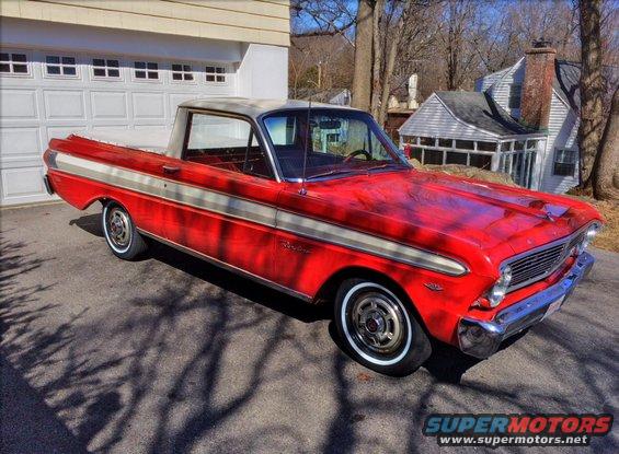 Red and white Ford Ranchero pickup truck parked in driveway, front 3/4 view
