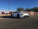 2015 Subaru Impreza - A white convertible sports car is parked outdoors near a temporary barrier.