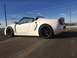 2015 Subaru Impreza - A white convertible sports car is parked on an asphalt surface under a blue sky with power lines in the background.