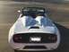 2015 Subaru Impreza - Rear view of a white convertible sports car with a black spoiler and dual humps behind the seats.