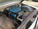 1960 Ford Starliner - The engine bay of a vintage vehicle, showing the air cleaner, hoses, and engine block.