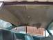 1960 Ford Starliner - Interior view of a car with a damaged headliner and teal upholstery, seen from the rear seats.