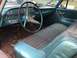 1960 Ford Starliner - The interior of a 1960 Ford Starliner shows turquoise vinyl and plaid upholstery, a large steering wheel, and a dashboard with a speedomete…