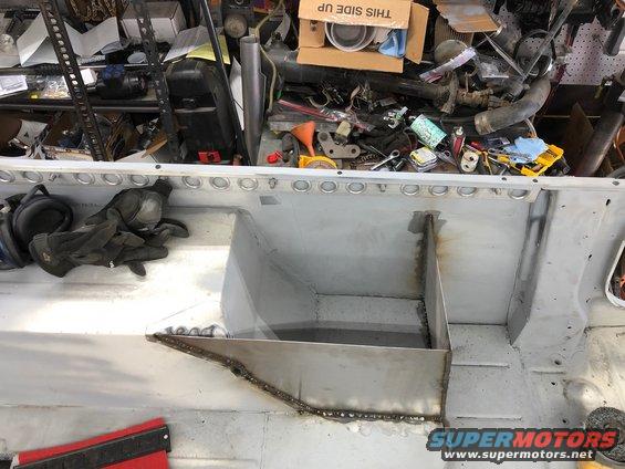 Interior of vehicle undergoing body work with tools and parts in background