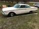 1960 Ford Starliner - Side view of a 1960 Ford Starliner coupe with trim removed, parked outdoors.