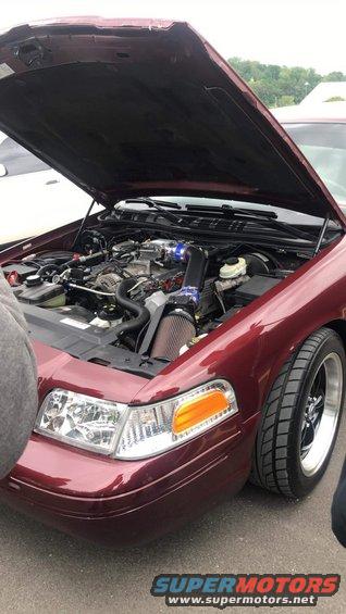 Maroon 2004 Ford Crown Victoria with hood open showing engine and aftermarket air intake