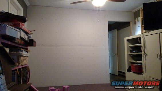 Interior scene with stacked boxes, shelves, and a ceiling fan