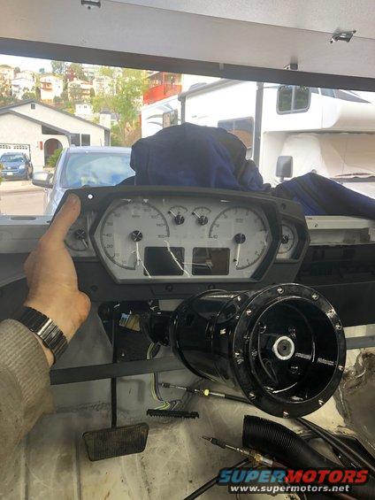 Dashboard instrument cluster and steering column assembly, with visible wiring and pedals